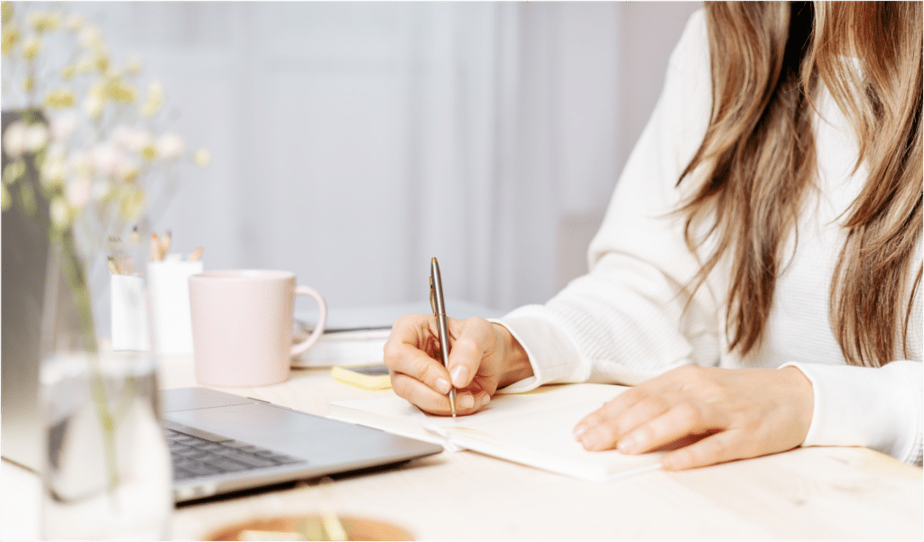 woman working at a desk in her hotel room